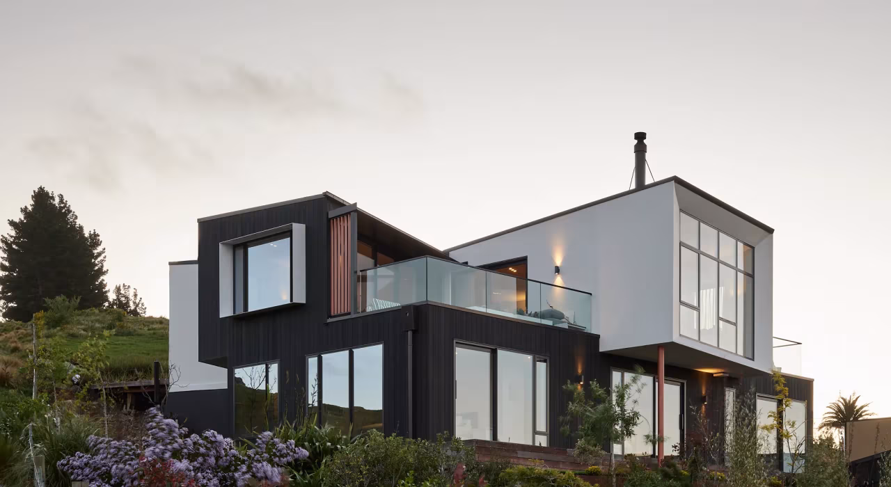 Haumoko House by Site Architecture. Two offset dark-clad volumes on Clifton hillside with timber plinth, Christchurch residential architecture.