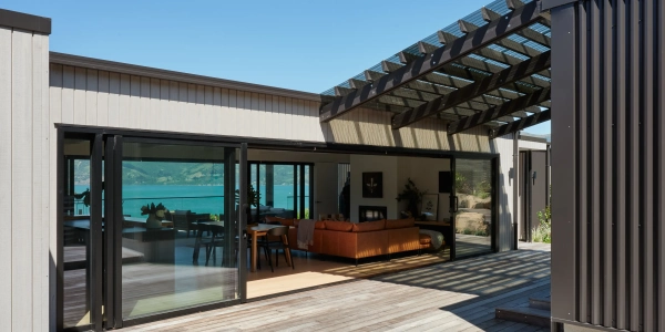 Akaroa Pentref by Site Architecture, covered outdoor pavilion with pergola looking out over Akaroa Harbour, Christchurch residential architecture.