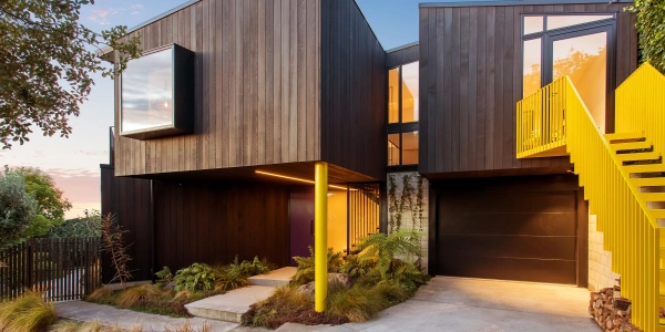 Dark cedar clad volumes with a bold yellow staircase, Clementine house, Site Architecture, St Andrews Hill, Christchurch