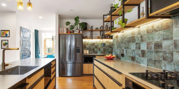 Renovated kitchen with open timber shelving, teal subway tile splashback and warm pendant lighting, Grange renovation by Site Architecture.