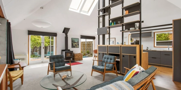 Living area with new timber and steel shelving system, mid-century furniture and skylight, Paulus alteration by Site Architecture.