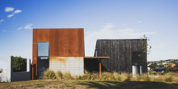 Drayton by Site Architecture, corten steel and charred larch volumes on the hillcrest at Mt Pleasant, Christchurch