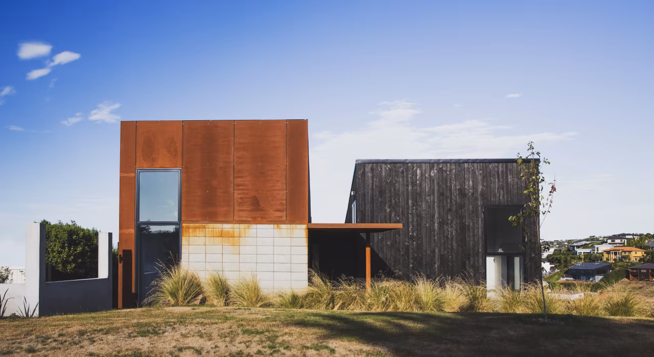 Drayton by Site Architecture, corten steel and charred larch volumes on the hillcrest at Mt Pleasant, Christchurch