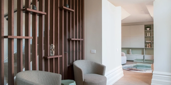 Living area of Suite 17 with timber slat wall detail, built-in shelving and soft natural light, Old Government Building Christchurch.