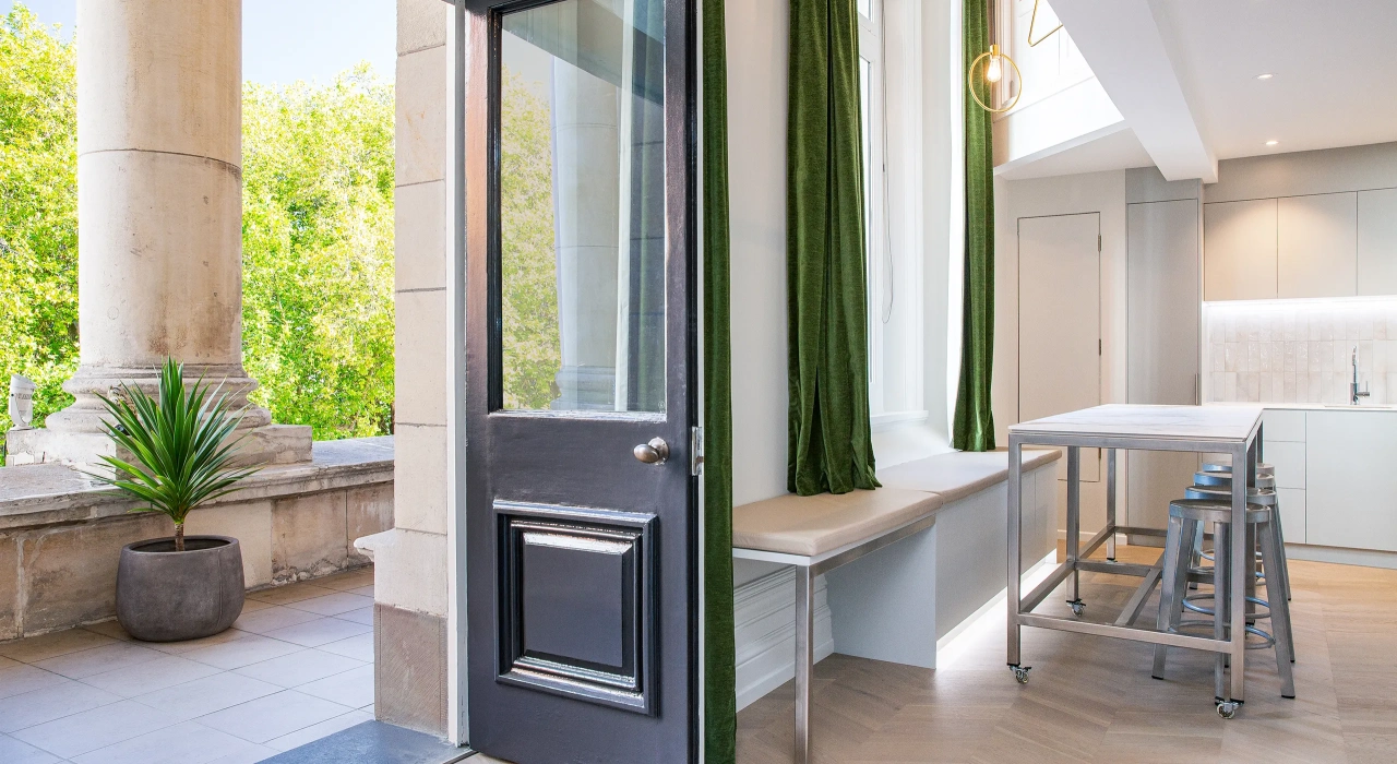 <img alt="Terrace entry with tall dark door, white-framed sash windows and Christchurch's Cathedral Square visible beyond." src="/images/s/i/t/e/-/site-architecture-suite-17-ogb-interior-architecture2-f68503f9.webp?description" width="2560" height="1707" />