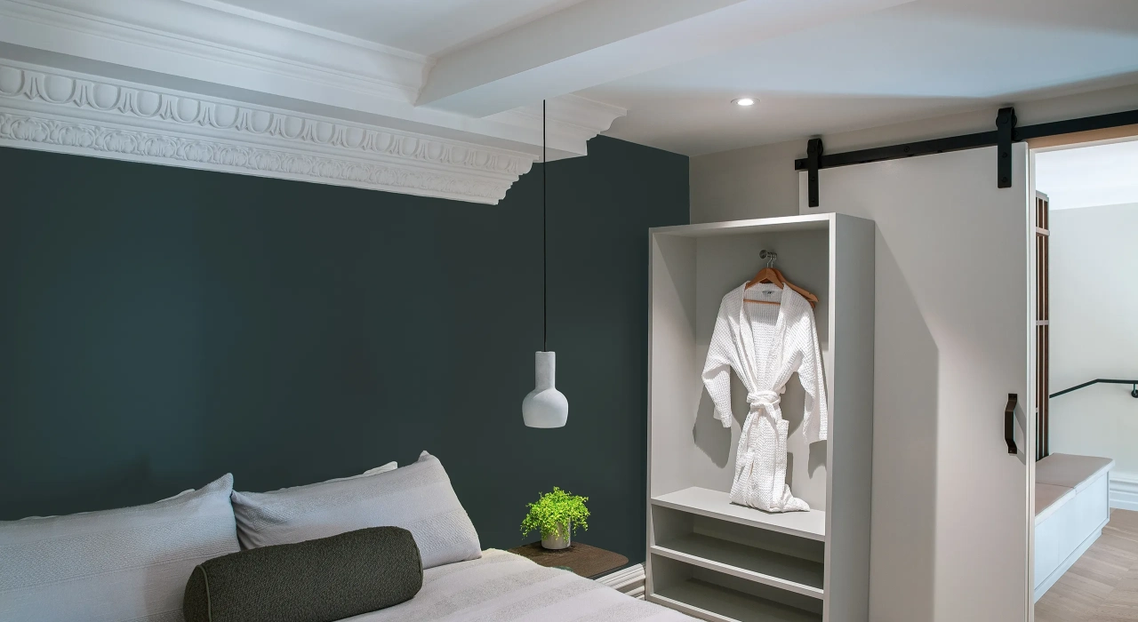 <img alt="Dark bedroom with soft wall lighting and artwork, a calm and considered retreat." src="/images/s/i/t/e/-/site-architecture-suite-17-ogb-interior-architecture8-7daf7882.webp?description" width="2560" height="1707" />